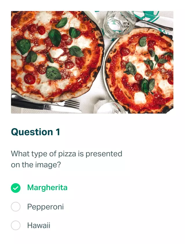 Photo of two margherita pizzas on a table.