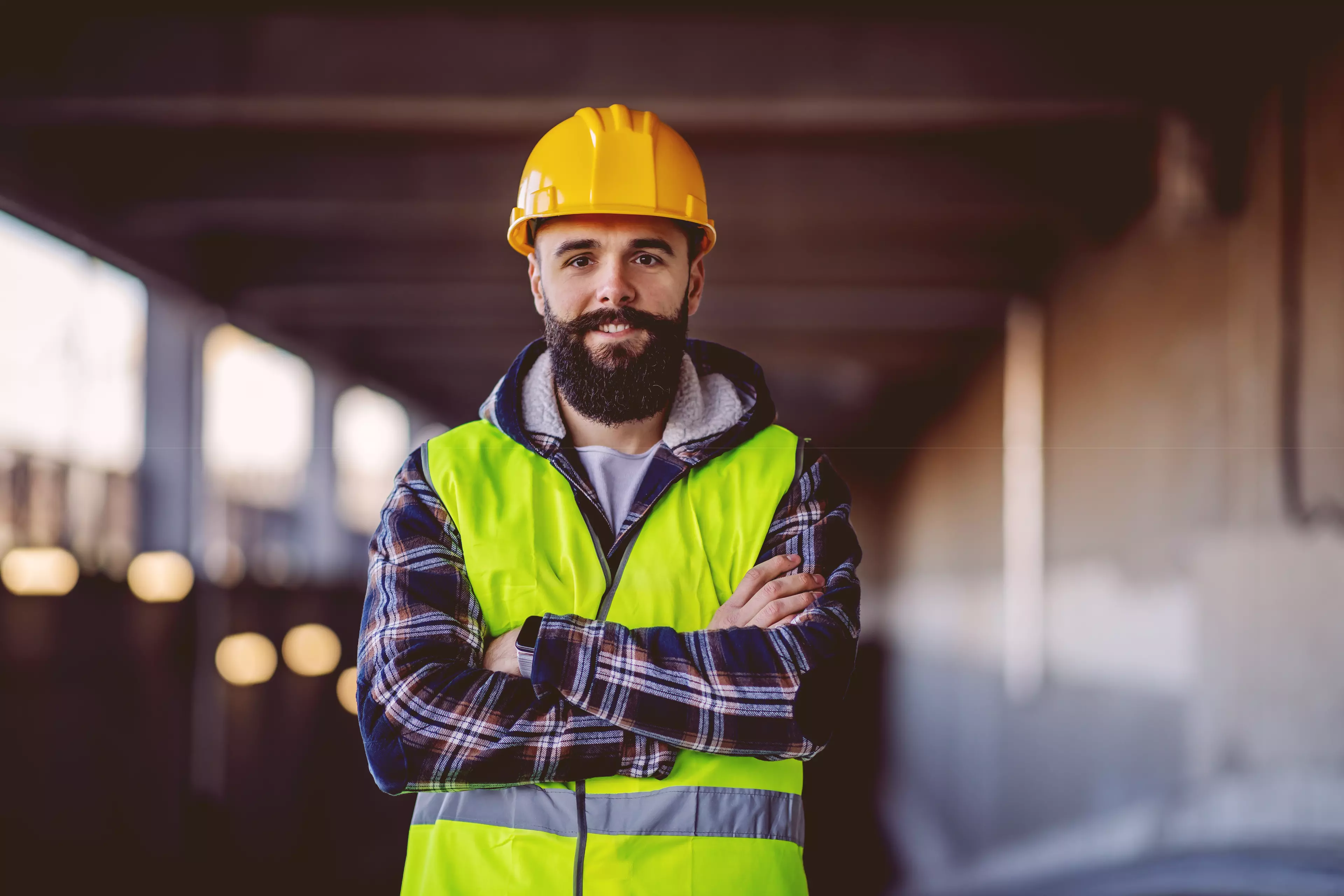 Happy, bearded construction site inspector, trained with Testportal for Microsoft Teams