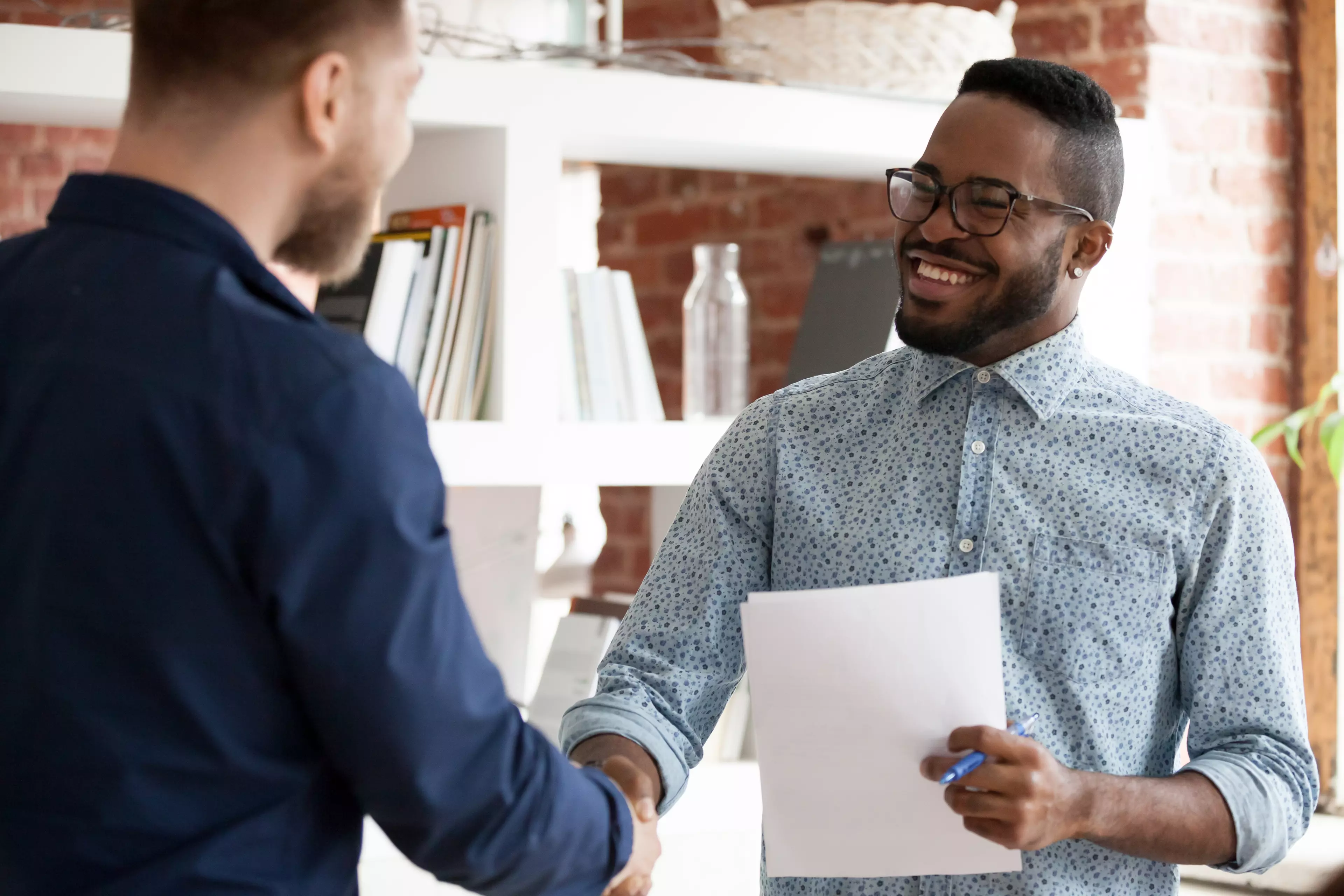 A man congratulating on passing an online exam